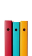© Firman Dasmir - Three colorful ring binders in red, blue, and yellow arranged in a row on a white background