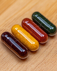 Leinwandbilder - A stunning close-up of herbal supplement pills arranged neatly on a wooden surface, with natural shadows enhancing their organic colors and textures,