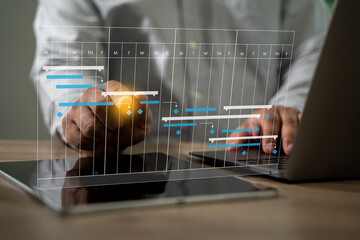 Poster - project management businessman using a cell phone and laptop to view a project plan