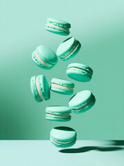 Wall Mural - Mint green macarons: A vibrant scene of pale mint green macarons, a popular French dessert, suspended gracefully in mid-air against a soft, gradient mint green background