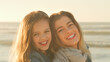 © Monkey Business - Portrait Of Smiling Mother And Daughter On Winter Beach Together In Golden Light