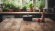 © musa - Rustic kitchen table with black pot, tomato, pepper mill, and herbs in window background.