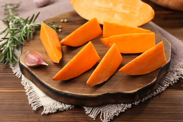 Sliced sweet potato on wooden table, closeup