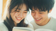 © smth.design - Asian young couple reading a book together in a cozy setting