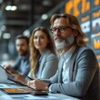 © Tumi - Confident businessman with colleagues in meeting.