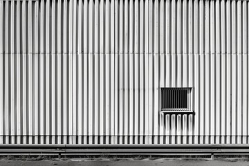 Aufkleber - A large white building with a small window and a metal bar on the window. The building appears to be empty and abandoned. AI generated.