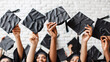 © liubovsolo - Several hands holding and throwing black graduation caps tassels isolated on white background