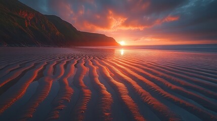 Wall Mural - Sunset beach, coastal cliff, red sky, sand patterns, calm ocean