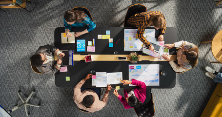 Aufkleber - Top Down View: Diverse and Creative Colleagues Working Together at The Conference Table In Stylish Office. Male and Female Business People Using Tablets, and Laptops to Analyze Business Data on Charts