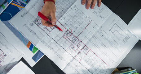 Aufkleber - Top Down View: Close Up on Engineer's Hand. Person Making a Round Mark with Red Pen on a Real Estate Project Blueprints or Architectural Plan