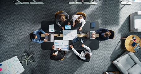 Aufkleber - Top Down View: Diverse Professionals Working on Business Statistics Reports and Digital Plans in an Office. Discussion and Data Analysis on Laptops and Charts. Teamwork, Innovation Concept