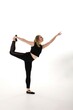 © Svetlana - Dancer performing an elegant pose in a minimalist studio setting