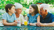 © Monkey Business - Grandparents With Grandchildren At Table Enjoying Snack At Outdoor Cafe Or Restaurant