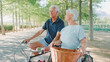 © Monkey Business - Senior Retired Couple On Vacation Cycling Along Tree Lined Country Road In Summer