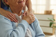 © New Africa - Caregiver supporting senior woman indoors, closeup. Home health care service