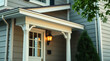 © MatandSterre - Charming Home Exterior: Classic Porch Design with White Columns and Warm Lighting.  A perfect blend of traditional architecture and modern comfort.