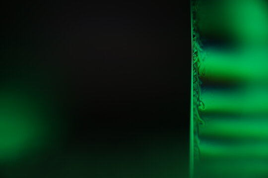 	
Green liquid surface on the dark background, colourful abstract, green shapes, minimalism, line of light, black and green