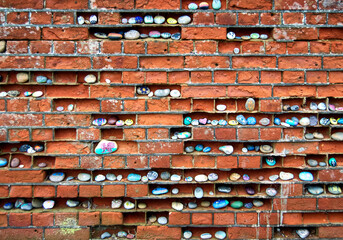 Aldeburgh eroded brick wall with painted pebbles