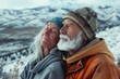 © Markus Schröder - Portrait of a tender caucasian couple in their 70s sporting a comfortable hoodie on snowy mountain range