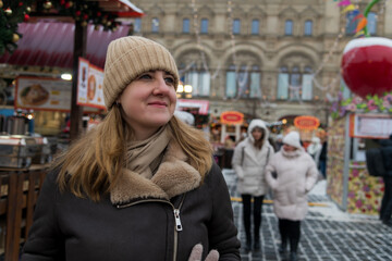 Winter market atmosphere with a woman enjoying the festive spirit in a snowy city setting