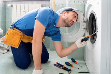 One repairman fixing malfunctioning kitchen oven problem