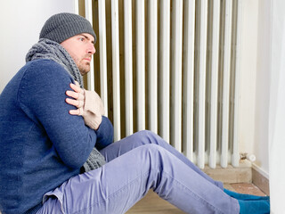 Wall Mural - Man feeling cold at home with home heating trouble