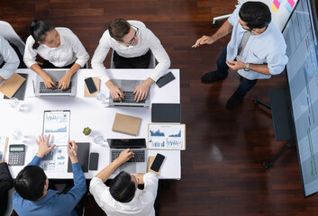 Leinwandbilder - Top view analyst team utilizing BI Fintech to analyze financial data at table in meeting room. Analytic BI dashboard power on paper for business insight and strategic marketing planning. Prudent