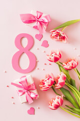 Wall Mural - Number eight with bouquet of tulips on a pink background. International Women's Day concept