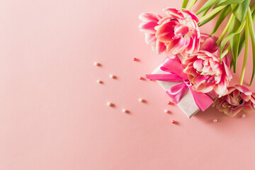Wall Mural - Pink tulips and hearts, gift box with ribbon on light pink background