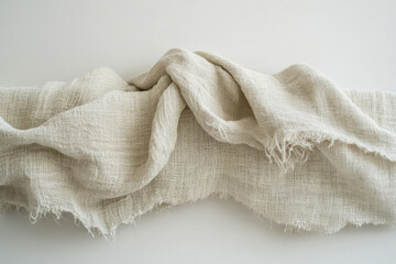 Aufkleber - Draped beige linen fabric with a raw, unfinished edge, showcasing its texture and natural beauty.
