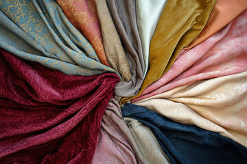 Poster - A collection of various colors and textures of fabrics arranged in a radial pattern.