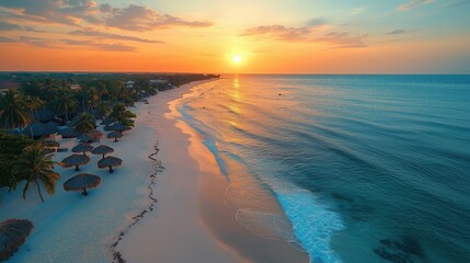 Wall Mural - Golden sun setting over a beautiful tropical beach with palm trees, umbrellas, white sand, and turquoise water creating a breathtaking vacation scene