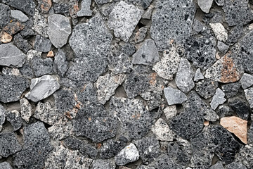 Poster - Irregularly shaped grey and white stones tightly packed together forming a textured surface.