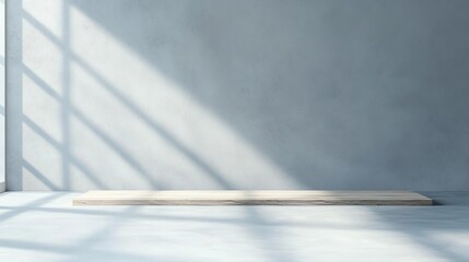 Poster - A minimalist room with a concrete wall and a wooden platform, illuminated by natural light casting shadows, creating a calm and spacious atmosphere perfect for design or display.