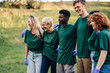 © Zamrznuti tonovi - Group of volunteers wearing matching shirts is smiling and posing for a photo
