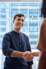 Aufkleber - Handshake of happy business man and business woman meeting in office. Young male bank manager greeting female client or partner as concept of cooperation success, partnership agreement. Vertical