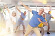 © JackF - Portrait of active mature people enjoying modern energetic dancing in a group in the studio