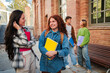 © Jose Calsina - Engaging Group of Diverse Students Chatting Happily at University Campus with Books in Hands, Enjoying Their Time, Demonstrating Friendship and Academic Spirit. Classmates Talking Together