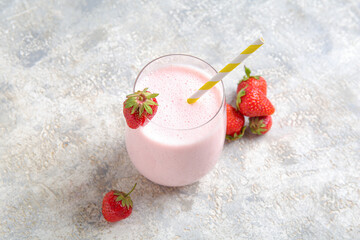 Wall Mural - Glass of tasty strawberry smoothie on light background