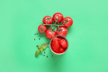 Wall Mural - Canned, fresh tomatoes and spices on green background