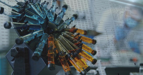  - Image of data processing over test tubes in laboratory