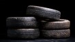 © NoorZafirah - Stack of Four Used Tires in Dark Background Highlighting the Texture and Wear of Each Tire, Ideal for Automotive or Recycling Related Themes