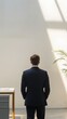 © Salsabila Ariadina - Businessman Standing in Sunlight Back View Office