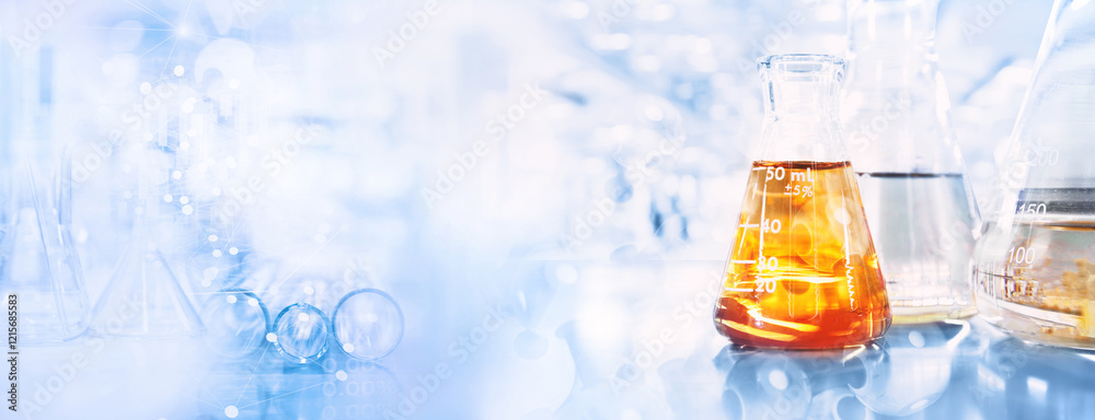 orange solution in flask and test tube in science research lab with ...