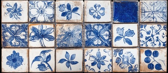 Poster - Blue and white decorative tiles with floral patterns arranged in a grid on aged surface with Copy Space