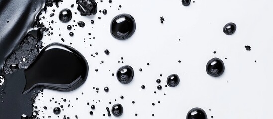 Poster - Black liquid on white surface with droplets and splashes in high detail providing texture and contrast, Copy Space available