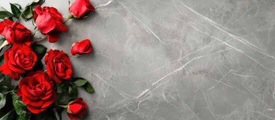 Poster - Red roses on a gray marble background with ample copy space for text placement