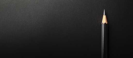 Poster - black background with a sharpened pencil on the right side with copy space for text placement.