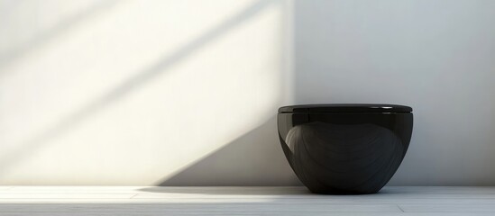 Poster - Black ceramic bowl on a minimalistic shelf against a light wall with shadows and copy space for text placement