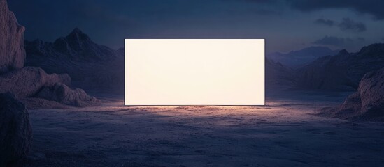 Poster - Empty white rectangular surface in a desert landscape during twilight with mountains in the background and copy space available for text.